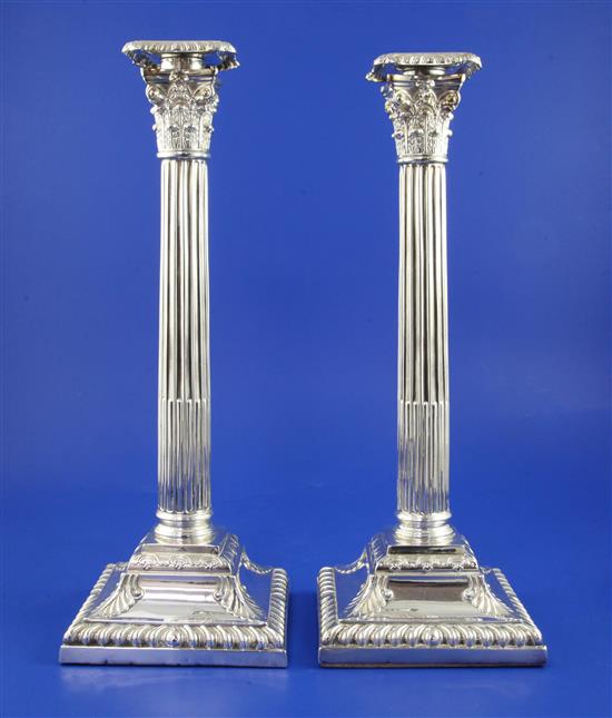 A pair of Victorian corinthian column candlesticks, weighted.